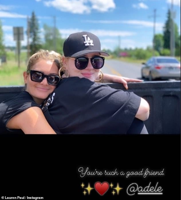 Long-term pals: Lauren also shared this throwback picture of herself hugging Adele while they were out on a road trip