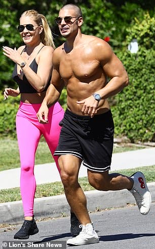 No shirt, no problem: Rondeau, 27, went shirtless in a pair of black wayfarers, black gym shorts and some white Comme des Garçons x Converse high tops