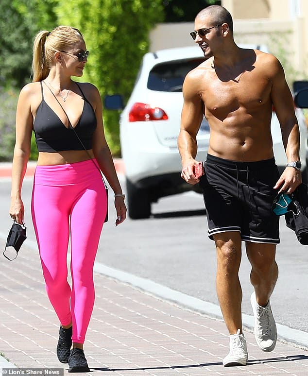 Accessorizing: She finished the look with a pair of black aviators, a silver necklace and a pair of black trainers