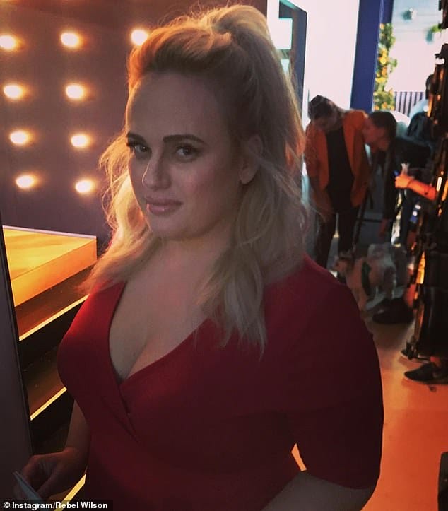 Disappearing act! Rebel Wilson continued to show off her incredible weight loss on Tuesday in a sizzling red low-cut dress
