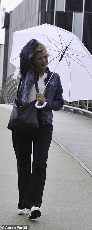 Chilly: The actress, 41, who plays Leanne Battersby, shielded herself with a large white umbrella as she took a break from filming