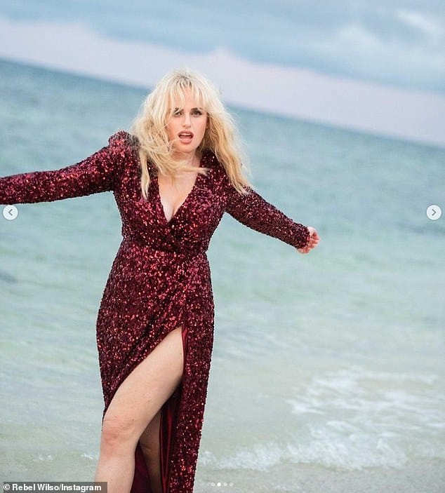 Work it! The star looked incredible in the extravagant number which featured a plunging neckline to tease her ample assets and a daring thigh-split