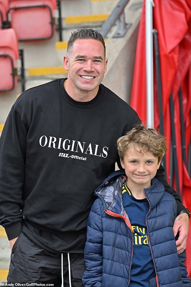 Father and son: Kieran posed with his eight-year-old son Jett, as he excitedly looked forward to the match