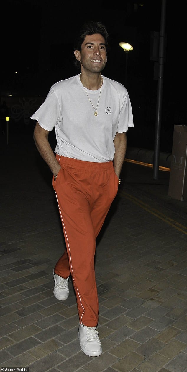 Night out: James later stepped out in Manchester in the same red jogging bottoms for a night out at Menagerie bar