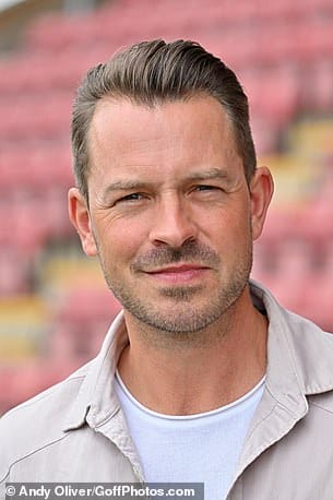 Looking good: Meanwhile, Hollyoaks star Ashley Taylor Dawson looked handsome, in a beige shirt layered over a white T-shirt