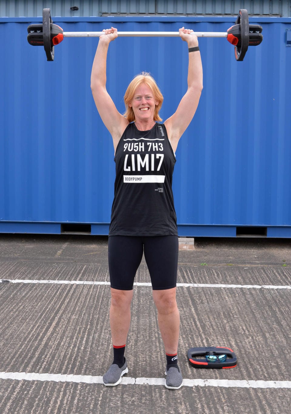 Maria Fox lifts weights high above her head